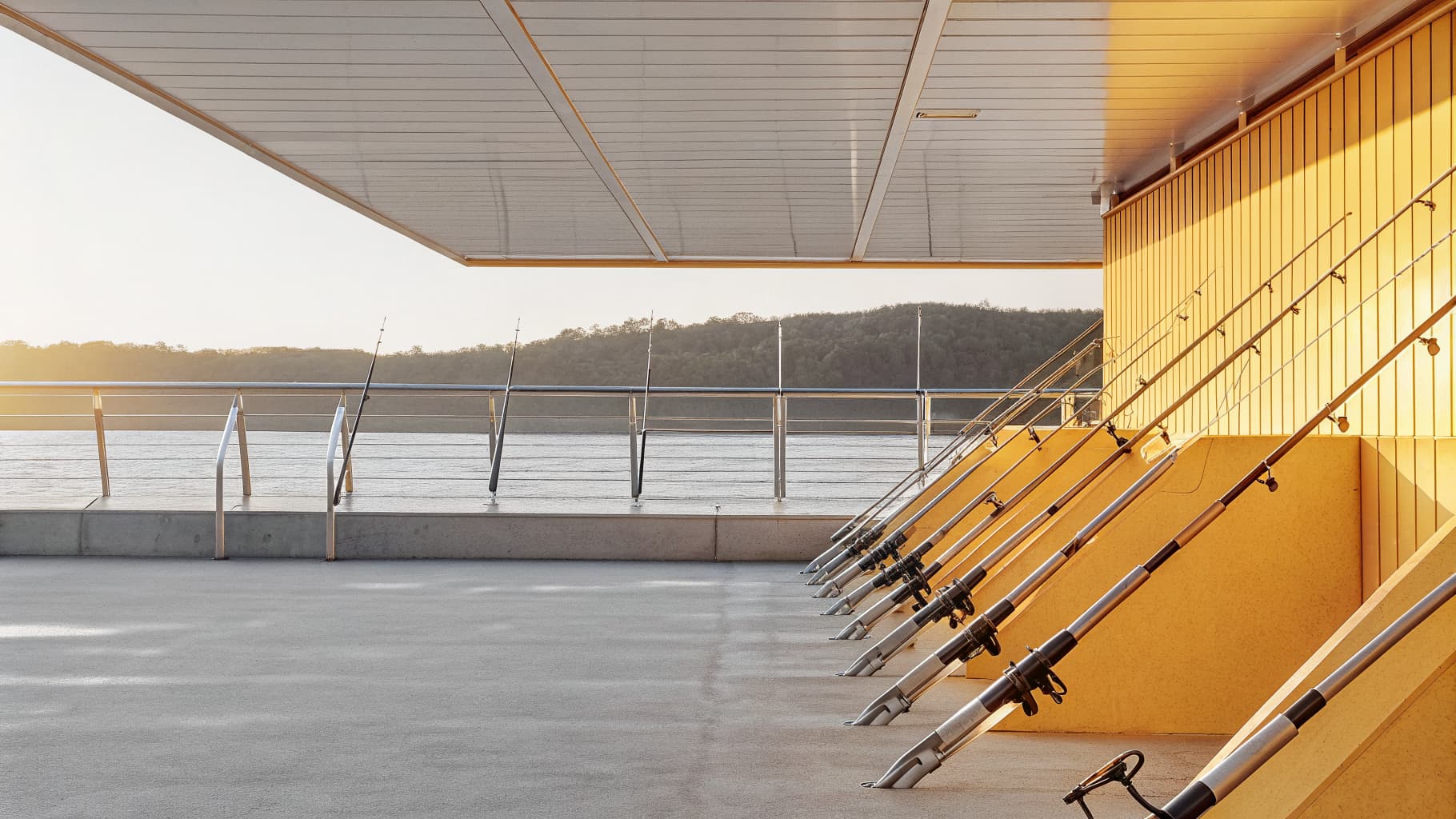 Fishing rods staged on a dock overlooking the water near Quepos, Costa Rica