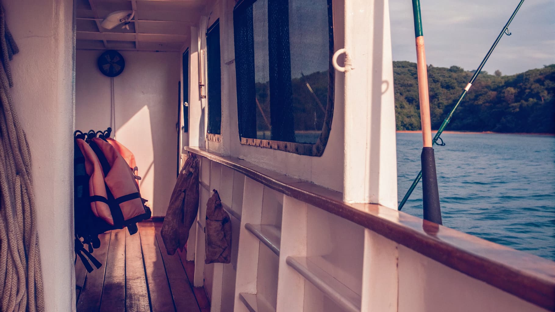 Family-friendly inshore fishing boat deck with life jackets and light tackle rigged near Quepos, Costa Rica